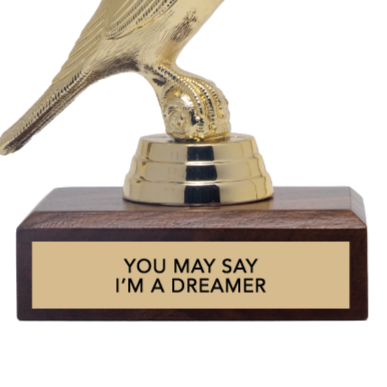 Gold trophy with wooden base and 'You May Say I'm a Dreamer' text