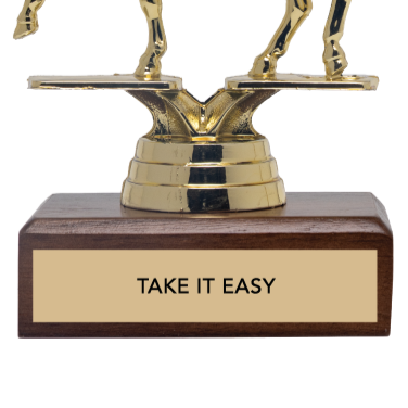 Gold trophy with 'Take It Easy' on a wooden base