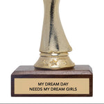 Gold trophy figure with a base reading 'My Dream Day Needs My Dream Girls' on a white background