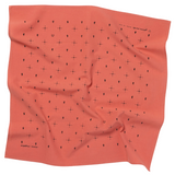 Coral-colored mantra bandana with black geometric pattern on a white background