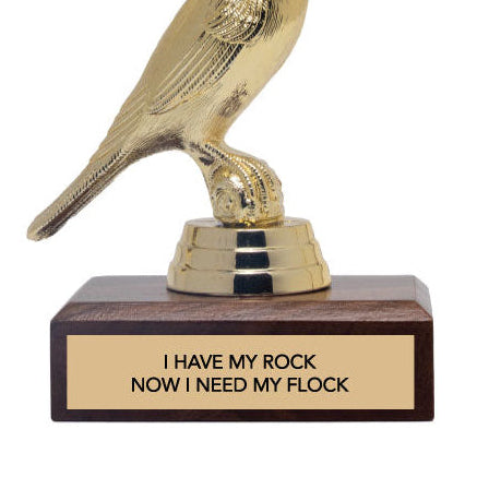 Gold bird-shaped trophy with a wooden base and 'i have my rock, now i need my flock' text on a white background