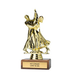 A gold-colored trophy figurine depicting a couple dancing, mounted on a rectangular brown wooden base with a gold plaque that reads 'NO LONGER LIVIN' IN SIN'.