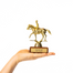 Gold trophy with a horse and rider figure on a white background