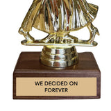 Gold dancing couple trophy with wooden base and engraved text 'we decided on forever' on a white background