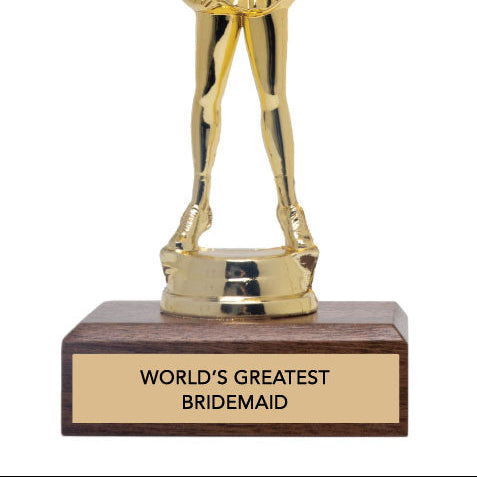 Gold trophy figure of a person in a cheerleading pose with 'world's greatest bridesmaid' text on a wooden base.